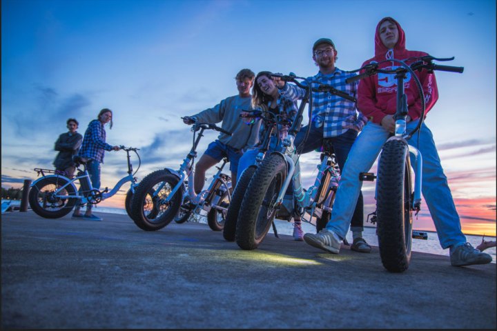 a group of people riding on the back of a motorcycle