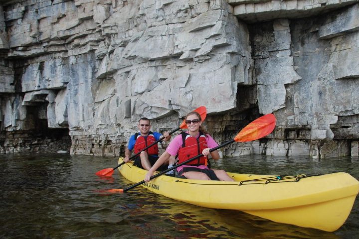 a person riding on the back of a boat in the water