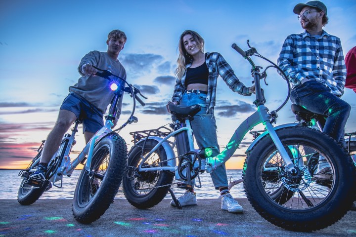 a group of people standing around a motorcycle