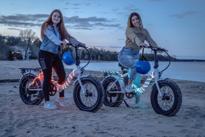 a group of people riding on the back of a bicycle