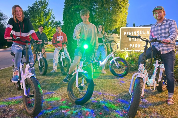 a group of people that are standing in the grass